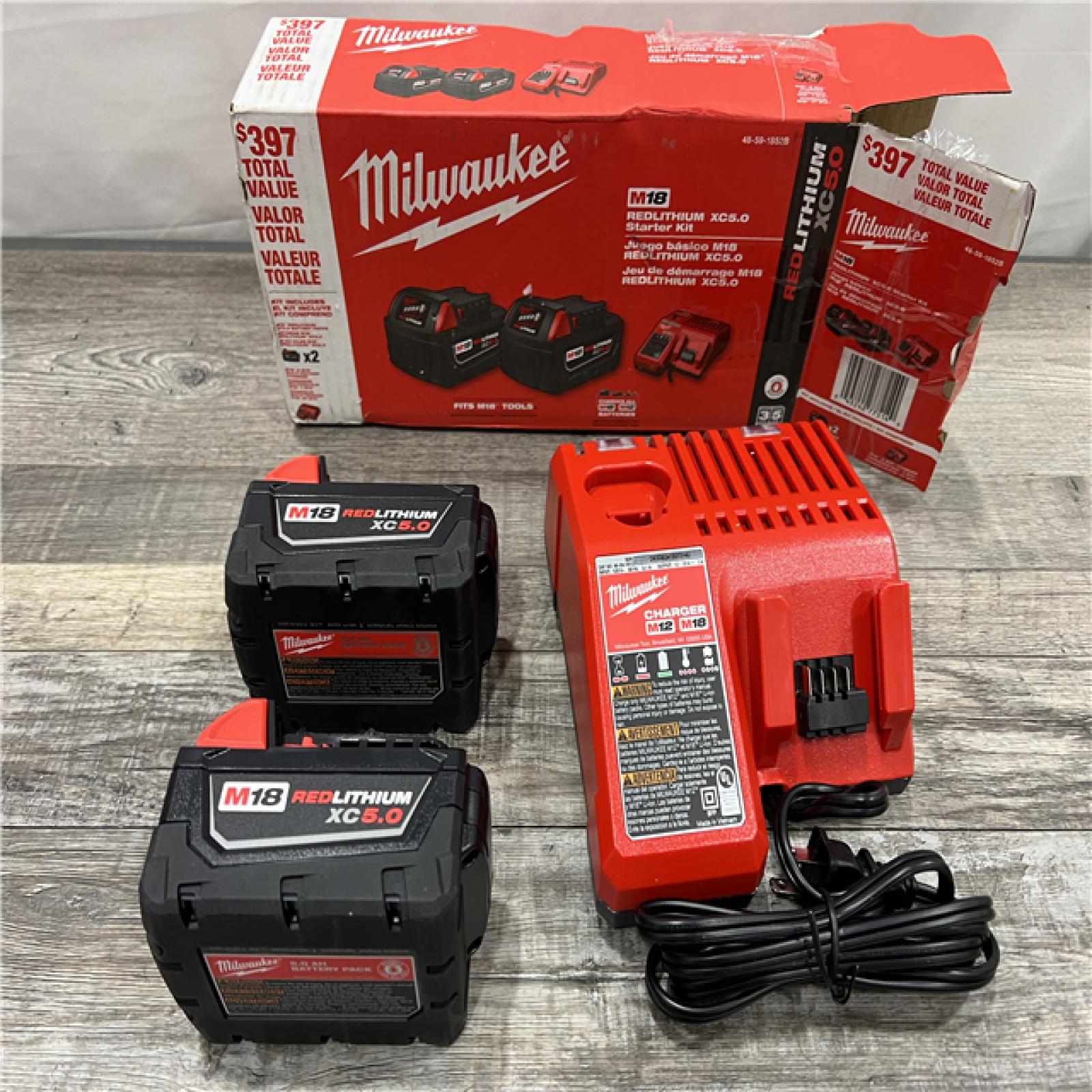 AS-IS Milwaukee M18 18-Volt Lithium-Ion XC Starter Kit with Two 5.0Ah Batteries / Charger (48-59-1852B)