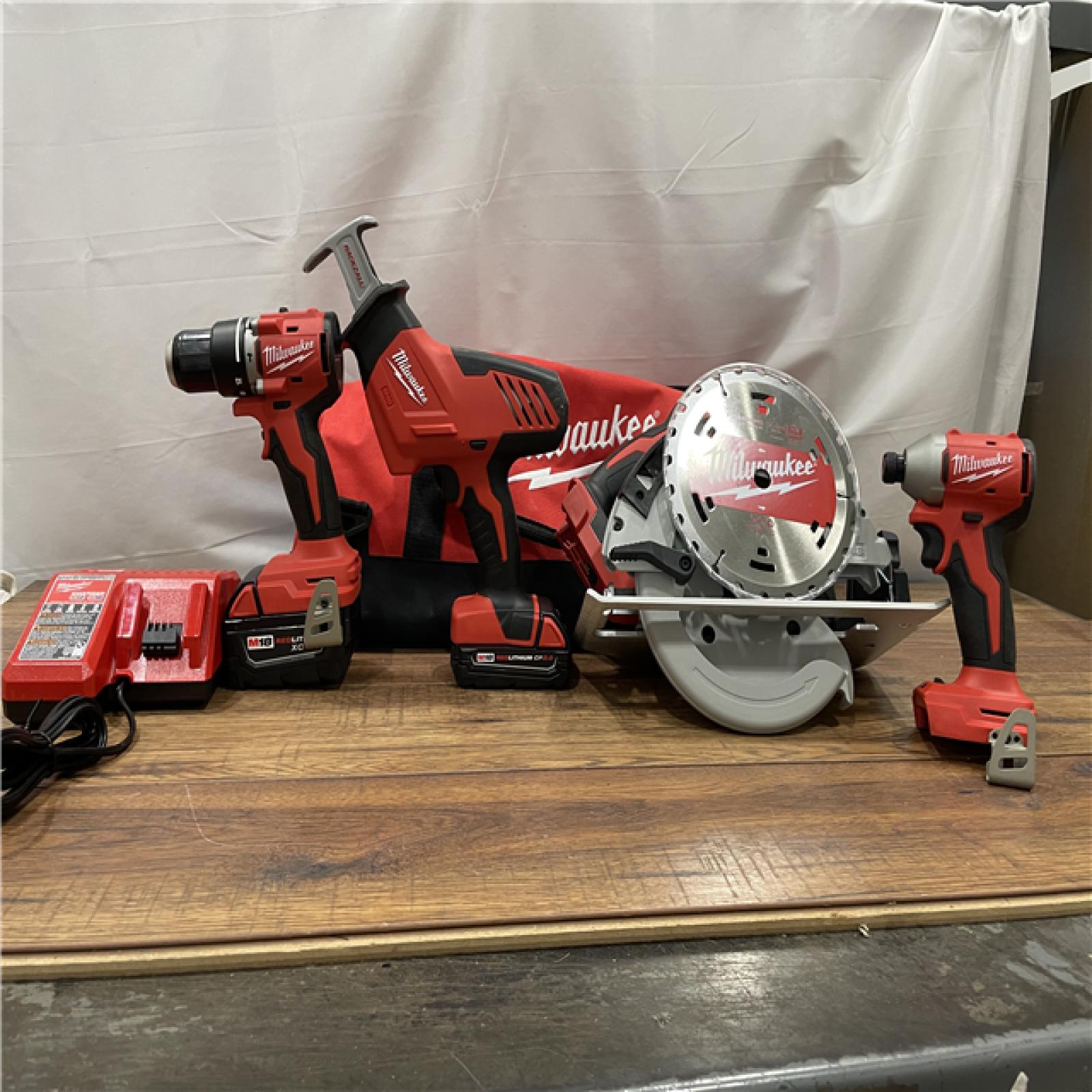 AS-IS Milwaukee M18 18-Volt Lithium-Ion Brushless Cordless Combo Kit (4-Tool) with 2-Batteries, 1-Charger and Tool Bag