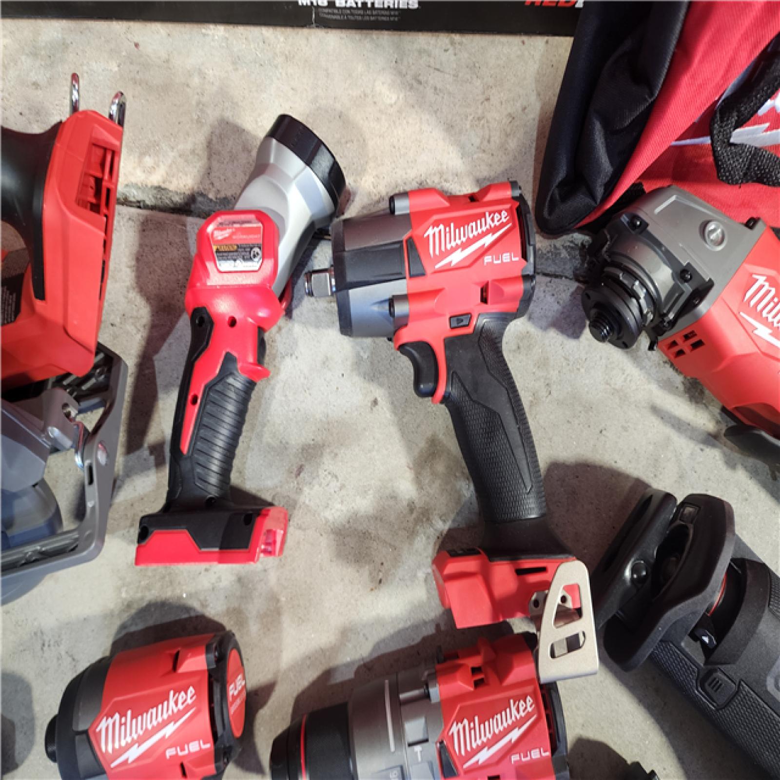 HOUSTON LOCATION - AS-IS (APPEARS LIKE NEW) Milwaukee M18 FUEL 18V Lithium-Ion Brushless Cordless Combo Kit with Two 5.0 Ah Batteries  1 Charger  2 Tool Bags (7-Tool)