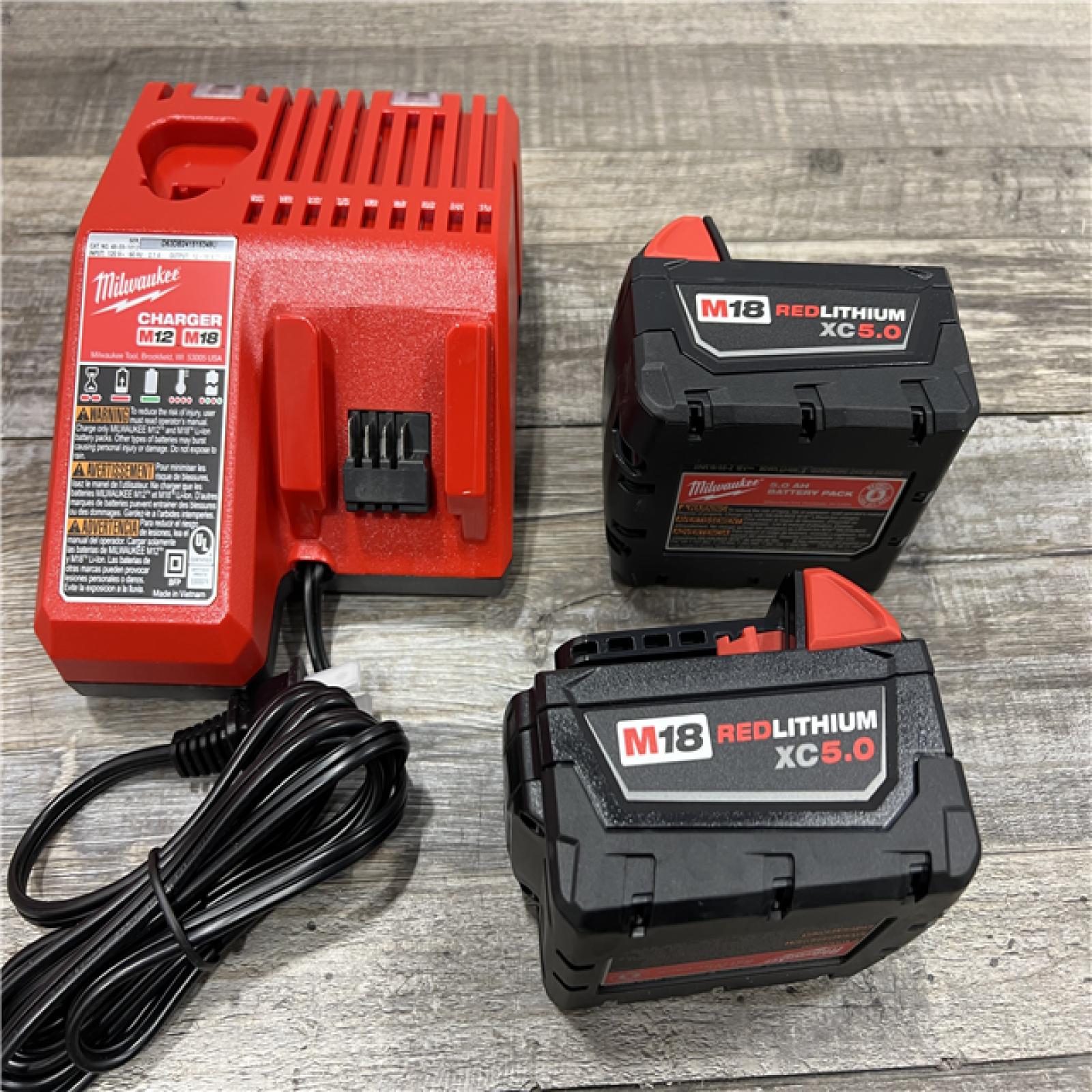 AS-IS Milwaukee M18 18-Volt Lithium-Ion XC Starter Kit with Two 5.0Ah Batteries / Charger (48-59-1852B)