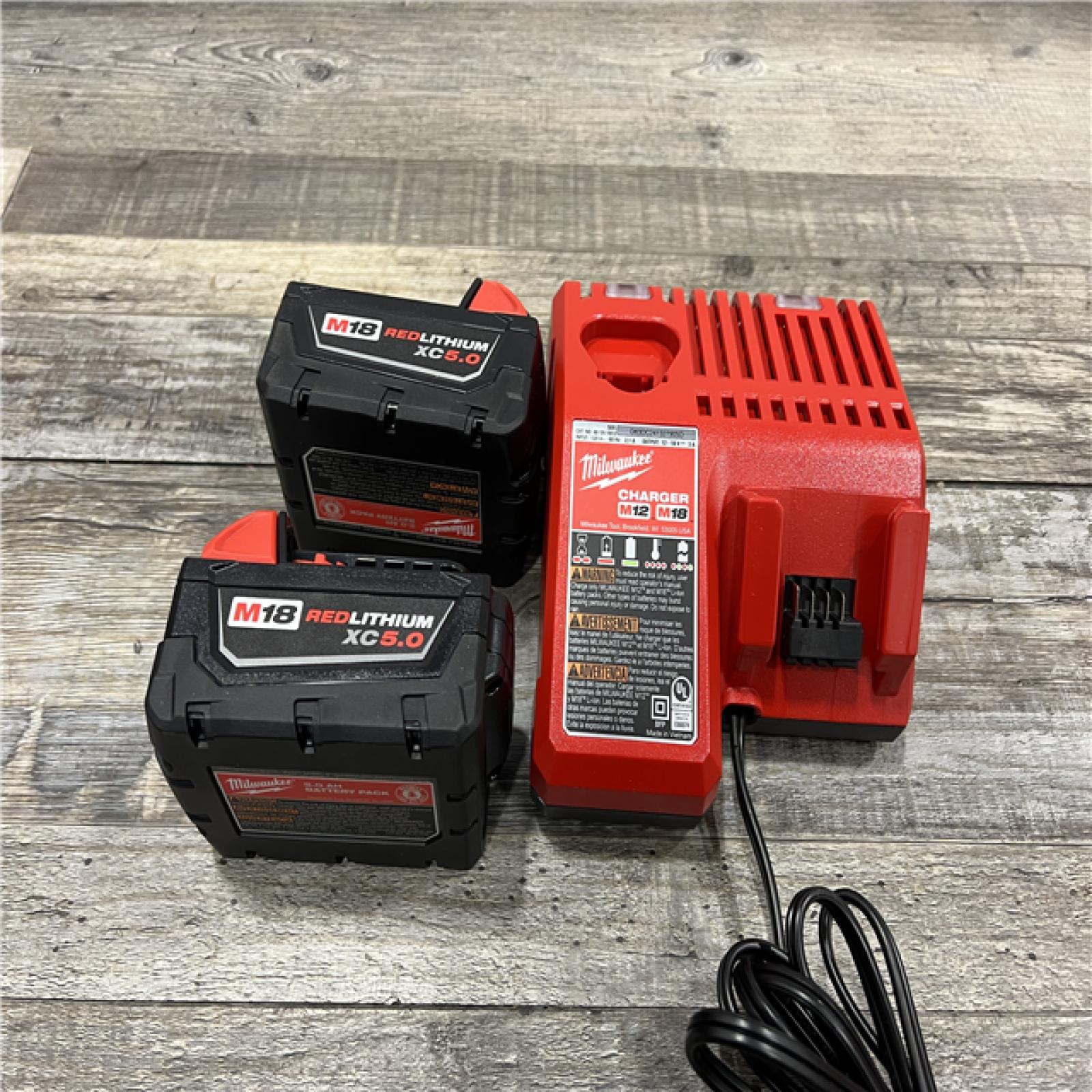 AS-IS Milwaukee M18 18-Volt Lithium-Ion XC Starter Kit with Two 5.0Ah Batteries / Charger (48-59-1852B)