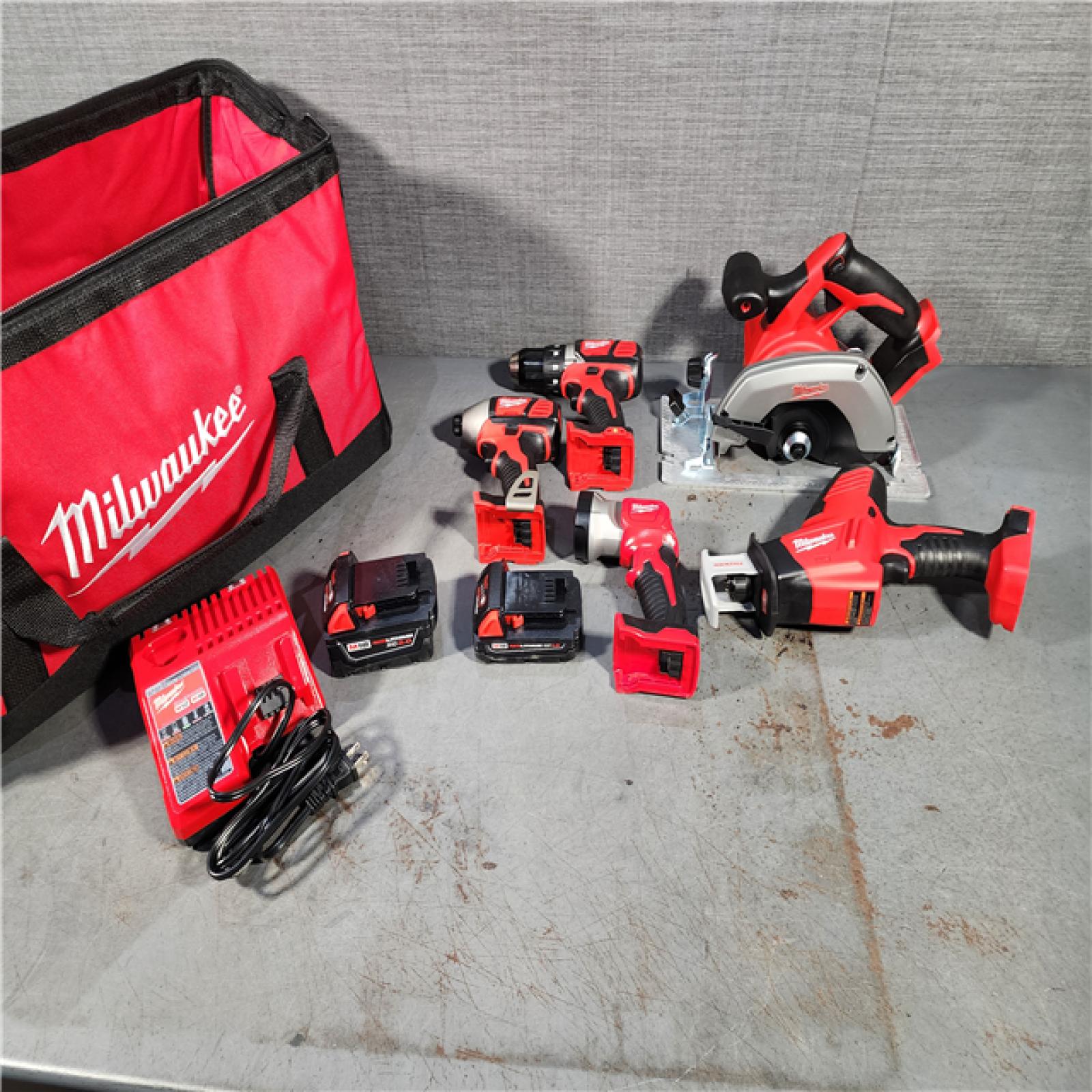 HOUSTON LOCATION - AS-IS (APPEARS LIKE NEW) Milwaukee M18 18-Volt Lithium-Ion Cordless Combo Tool Kit (5-Tool) with (1) 3.0Ah and (1) 1.5Ah Battery, (1) Charger, (1) Tool Bag