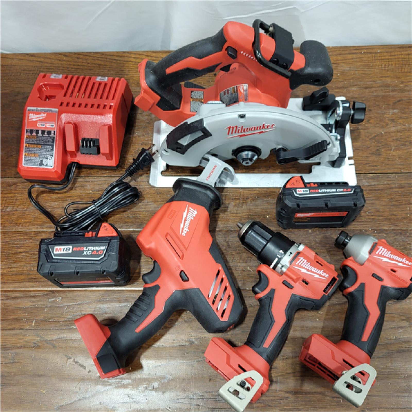 AS-IS Milwaukee M18 18-Volt Lithium-Ion Brushless Cordless Combo Kit (4-Tool) with 2-Batteries, 1-Charger and Tool Bag