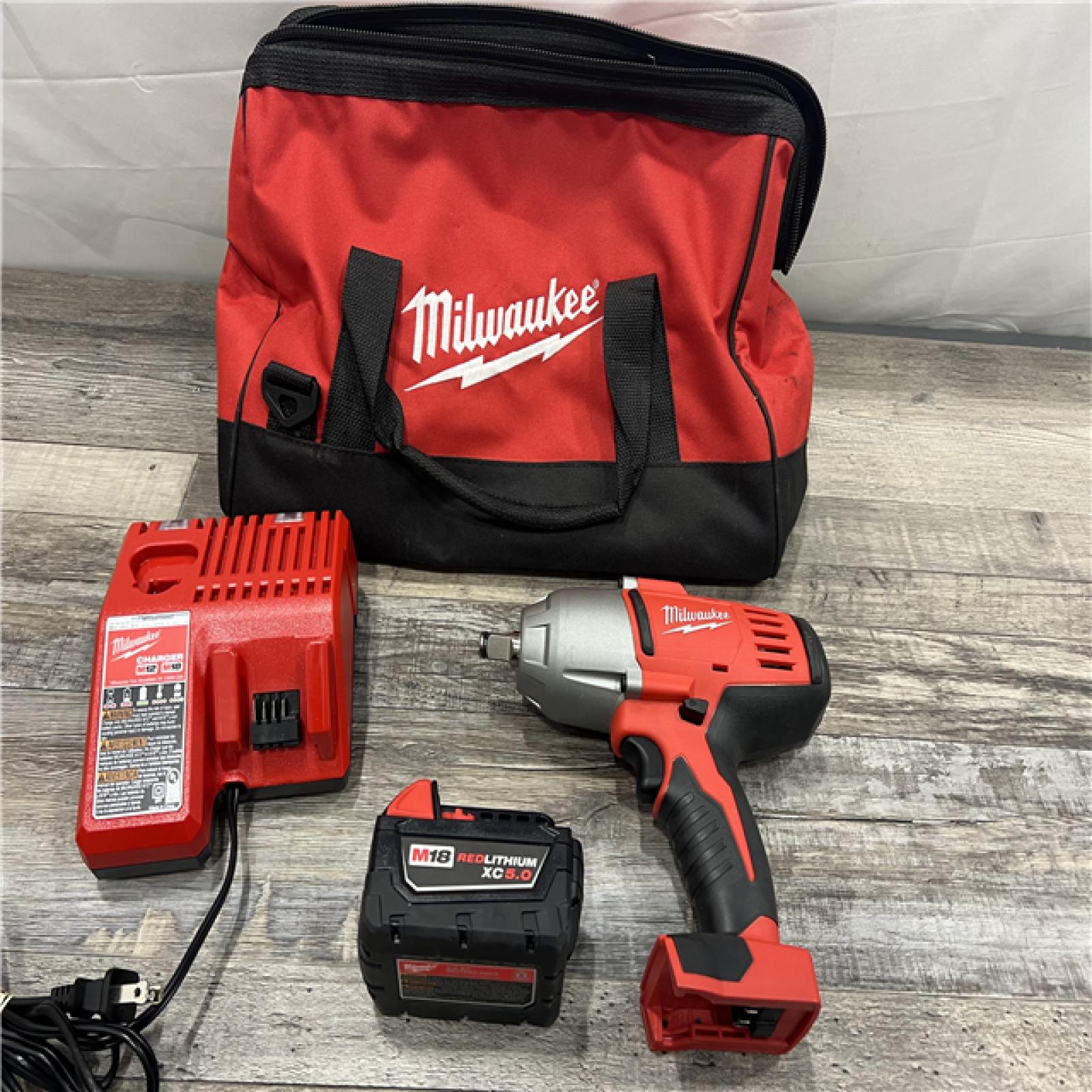 AS-IS MILWAUKEE M18 18-Volt Lithium-Ion Cordless 1/2 in. Impact Wrench W/ Friction Ring W/ (1) 5.0Ah Battery and Charger