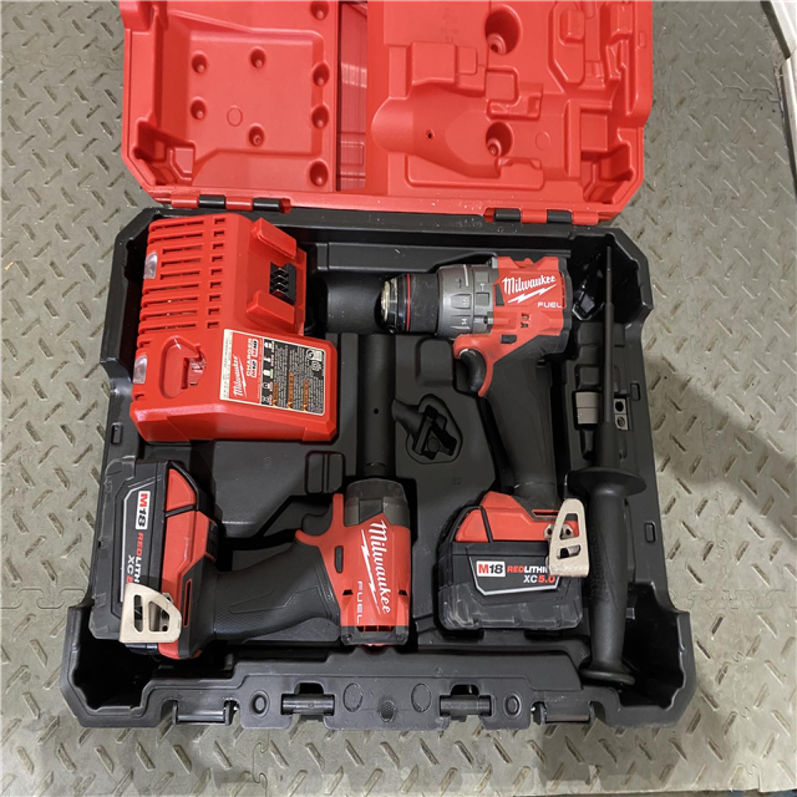 Houston location AS-IS Milwaukee 3697-22 M18 FUEL 1/2 Hammer Driller/Driver &1/4 Hex Impact Driver 2 Tool Combo Kit