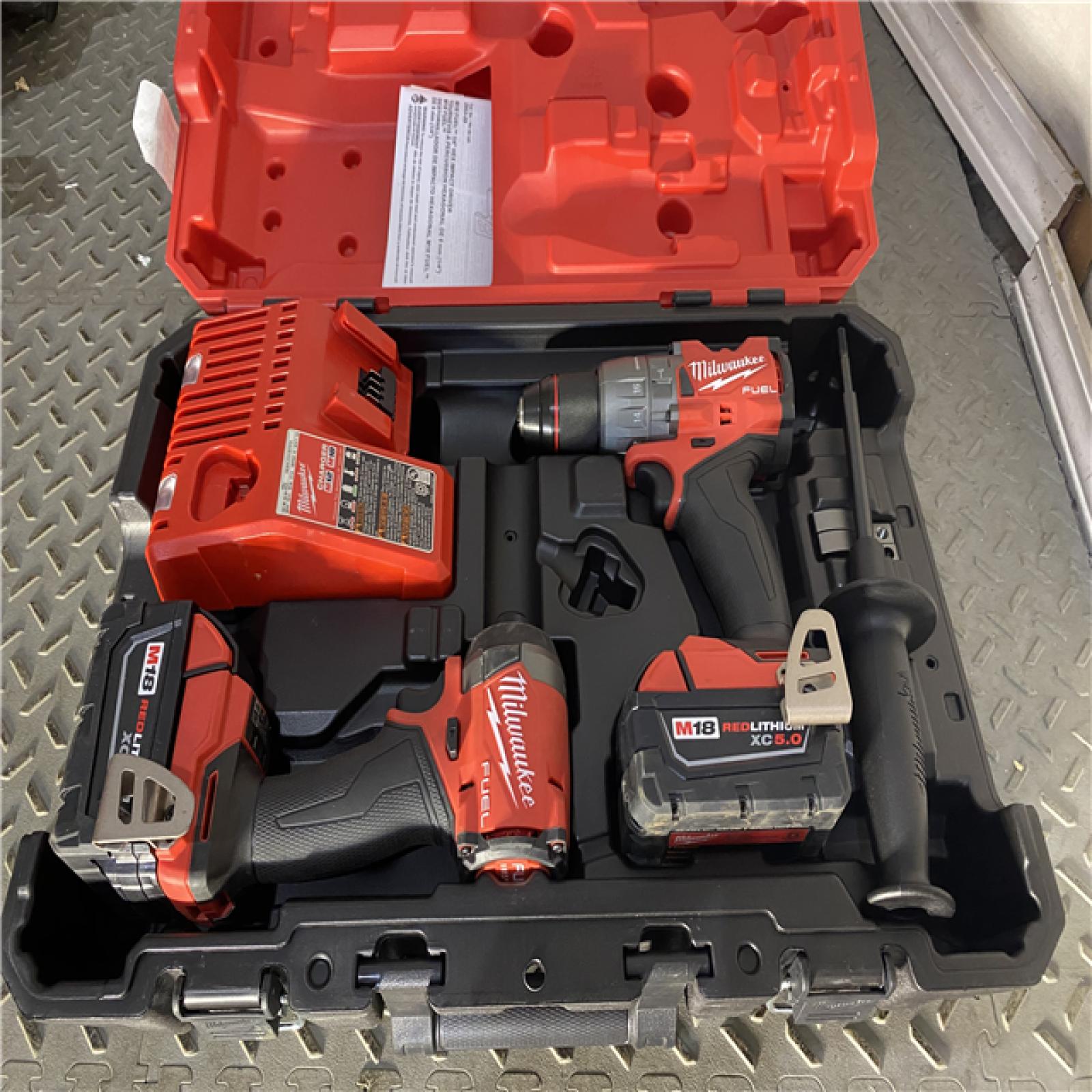 Houston location AS-IS Milwaukee 3697-22 M18 FUEL 1/2 Hammer Driller/Driver &1/4 Hex Impact Driver 2 Tool Combo Kit