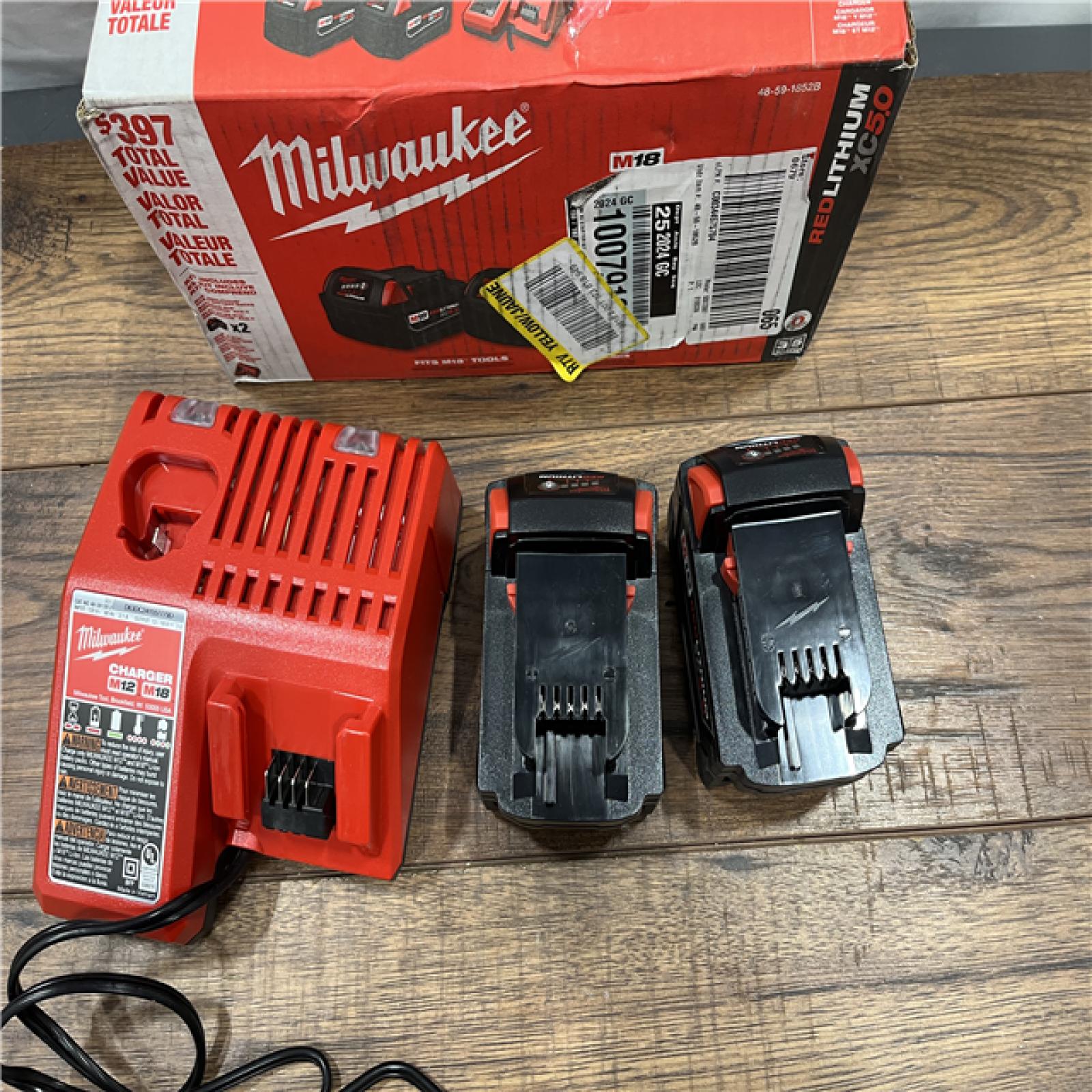 AS-IS Milwaukee M18 18-Volt Lithium-Ion XC Starter Kit with Two 5.0Ah Batteries / Charger (48-59-1852B)