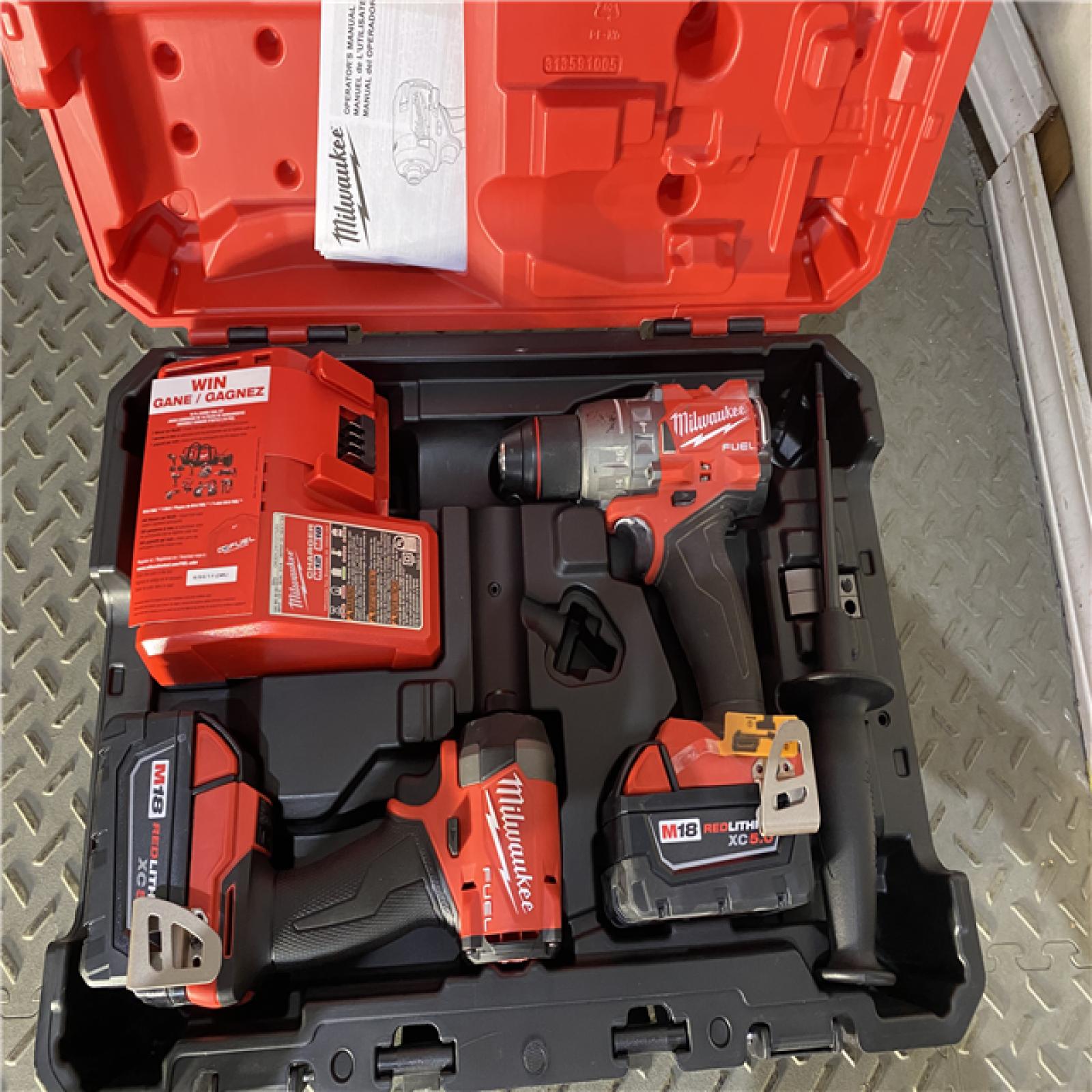 Houston location AS-IS Milwaukee 3697-22 M18 FUEL 1/2 Hammer Driller/Driver &1/4 Hex Impact Driver 2 Tool Combo Kit