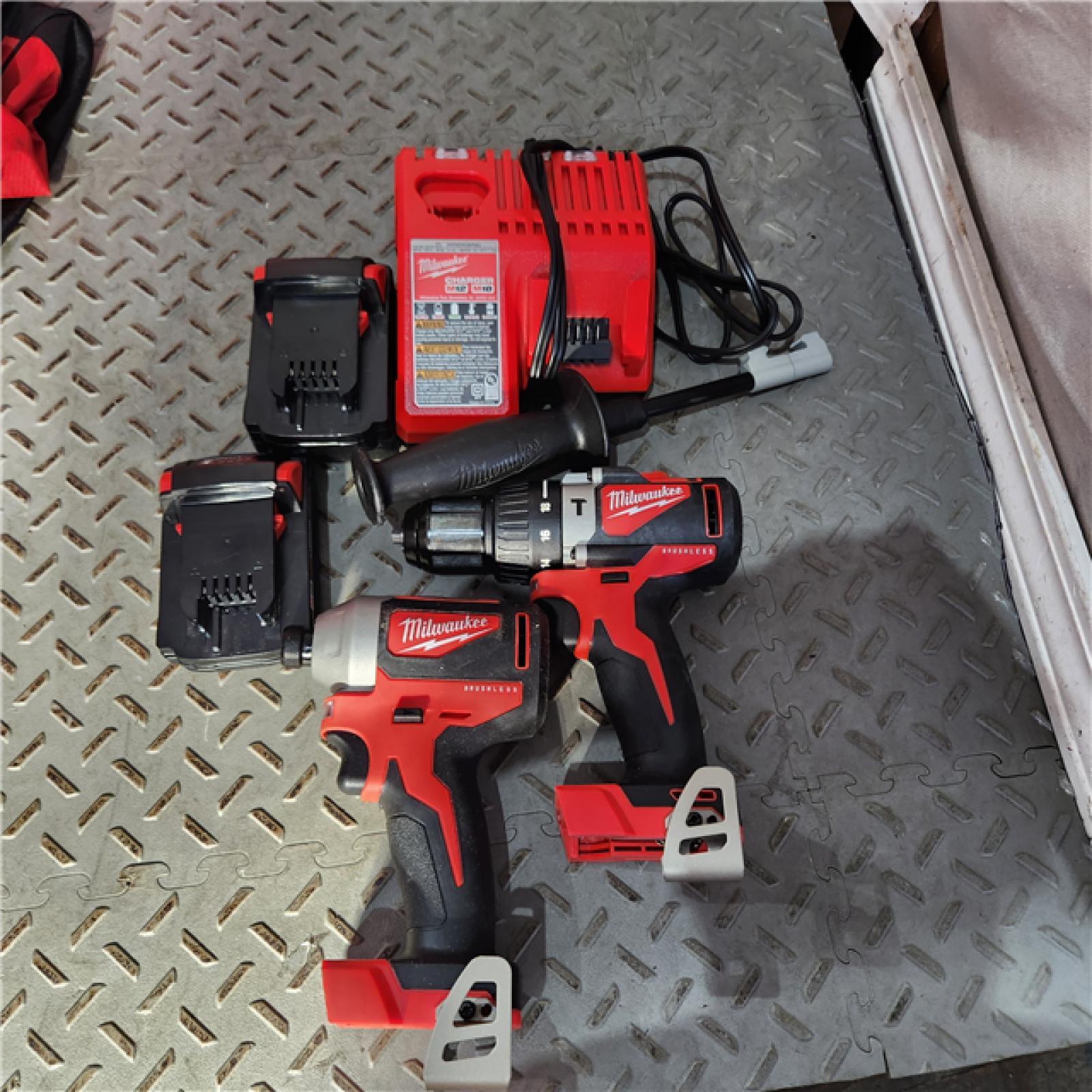 Houston location AS-IS MILWAUKEE M18 18V Lithium-Ion Brushless Cordless Hammer Drill/Impact Combo Kit (2-Tool) with 2 Batteries, Charger and Bag