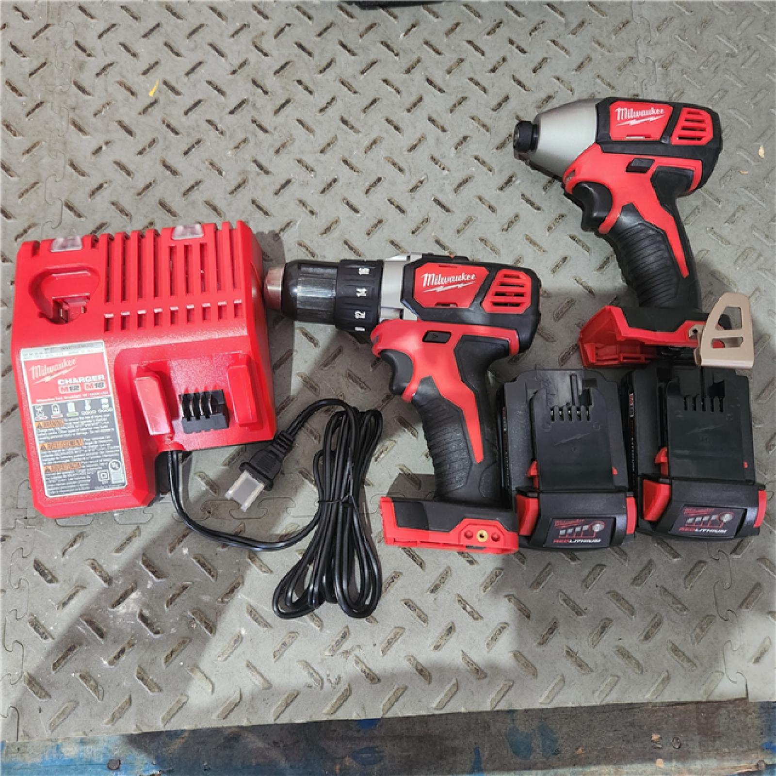 Houston location AS-IS MILWAUKEE M18 18V Lithium-Ion Cordless Drill Driver/Impact Driver Combo Kit (2-Tool) W/ Two 1.5Ah Batteries, Charger Tool Bag