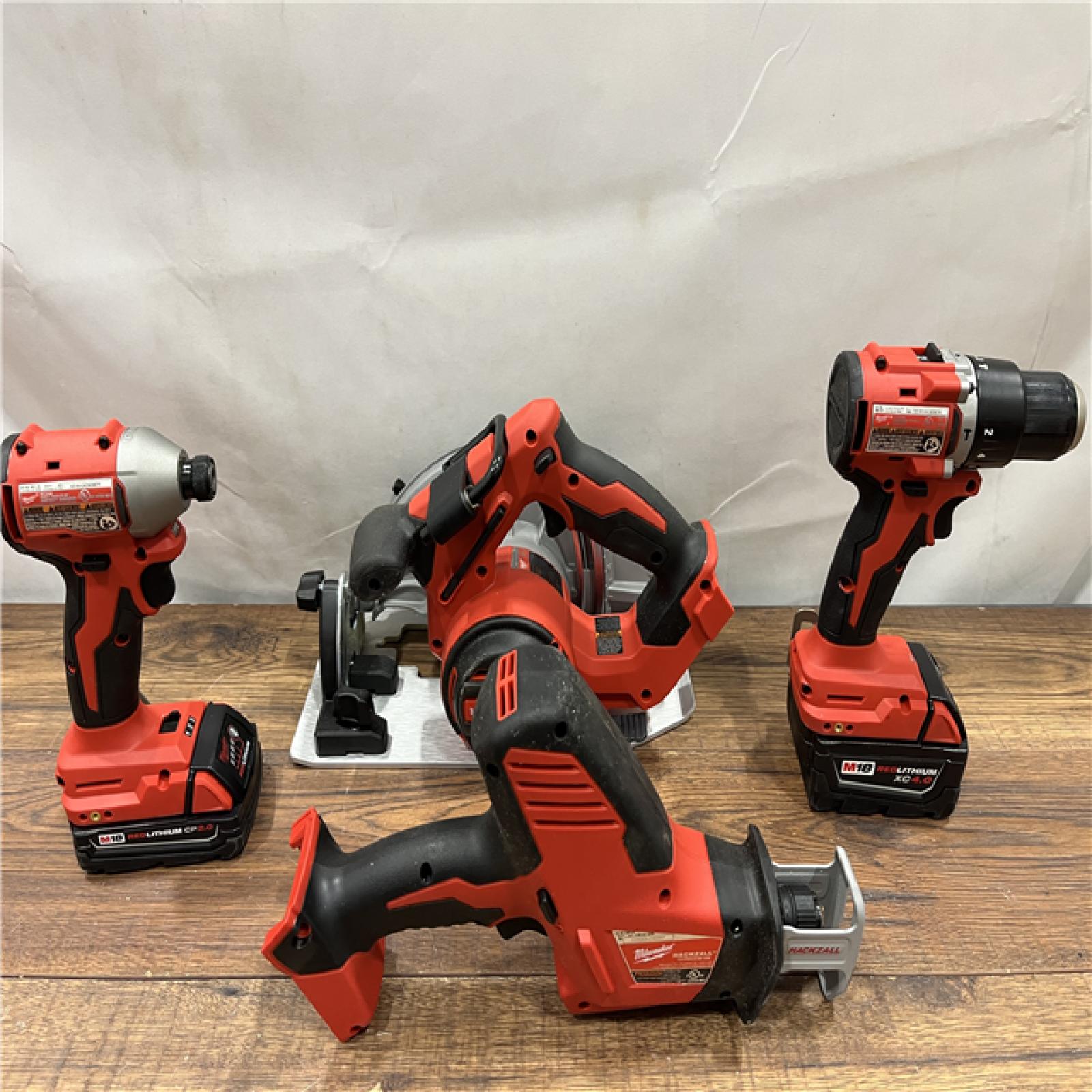 AS IS Milwaukee M18 18-Volt Lithium-Ion Brushless Cordless Combo Kit (4-Tool) with 2-Batteries, 1-Charger and Tool Bag