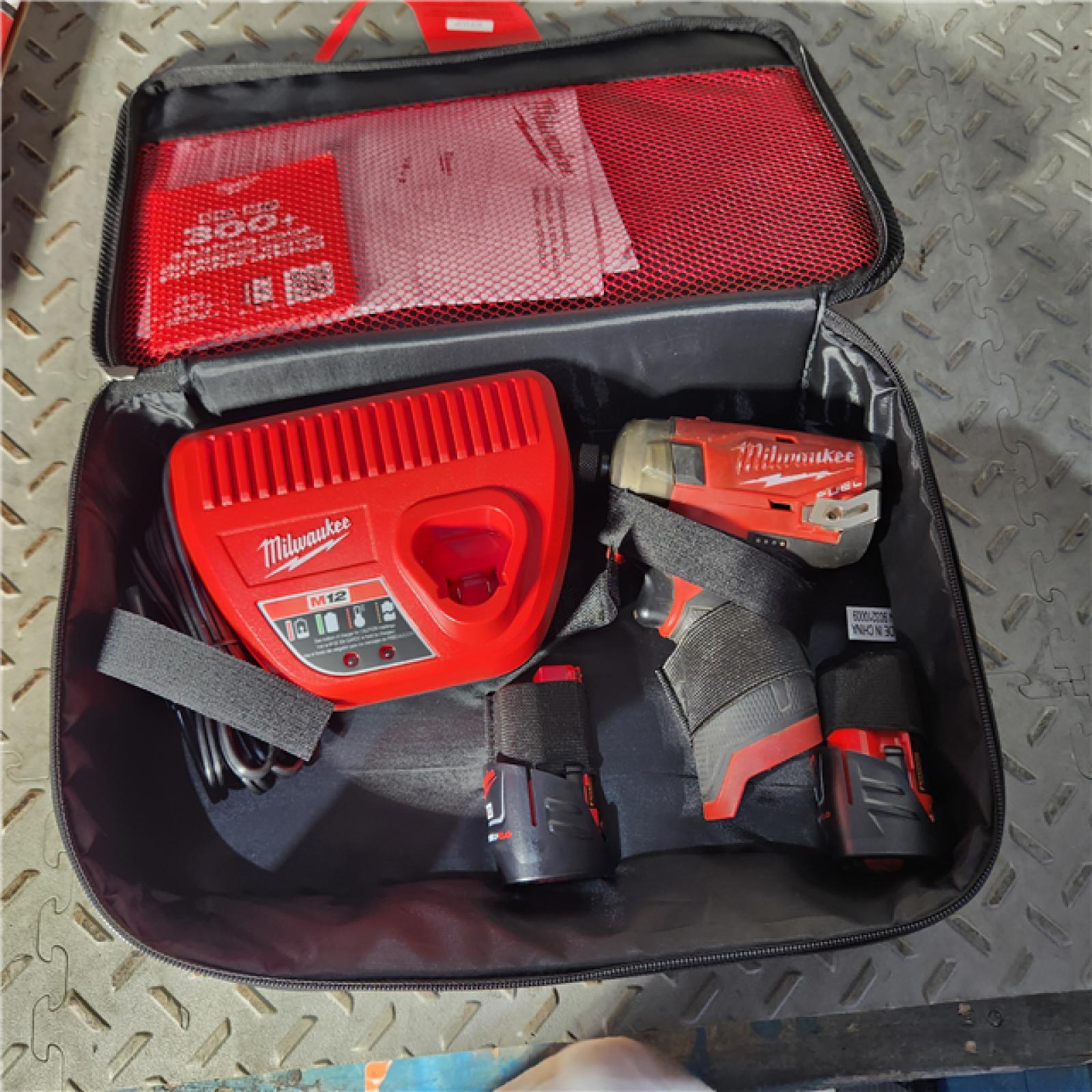 Houston location AS-IS MILWAUKEE M12 FUEL SURGE 12V Lithium-Ion Brushless Cordless 1/4 in. Hex Impact Driver Compact Kit W/Two 2.0Ah Batteries, Bag