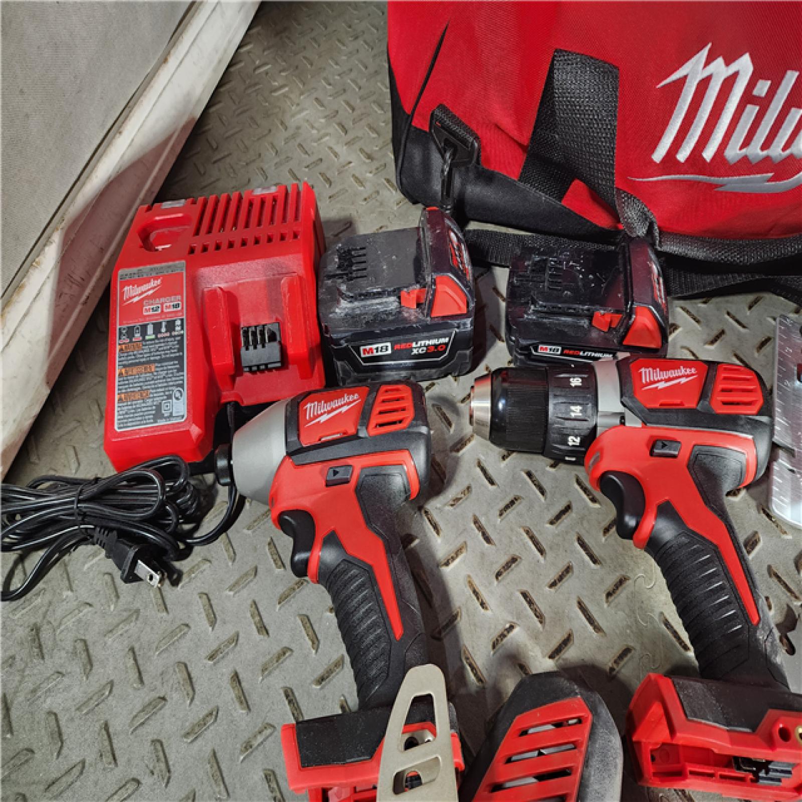 HOUSTON LOCATION - AS-IS Milwaukee M18 18-Volt Lithium-Ion Cordless Combo Tool Kit (5-Tool) with (1) 3.0Ah and (1) 1.5Ah Battery, (1) Charger, (1) Tool Bag