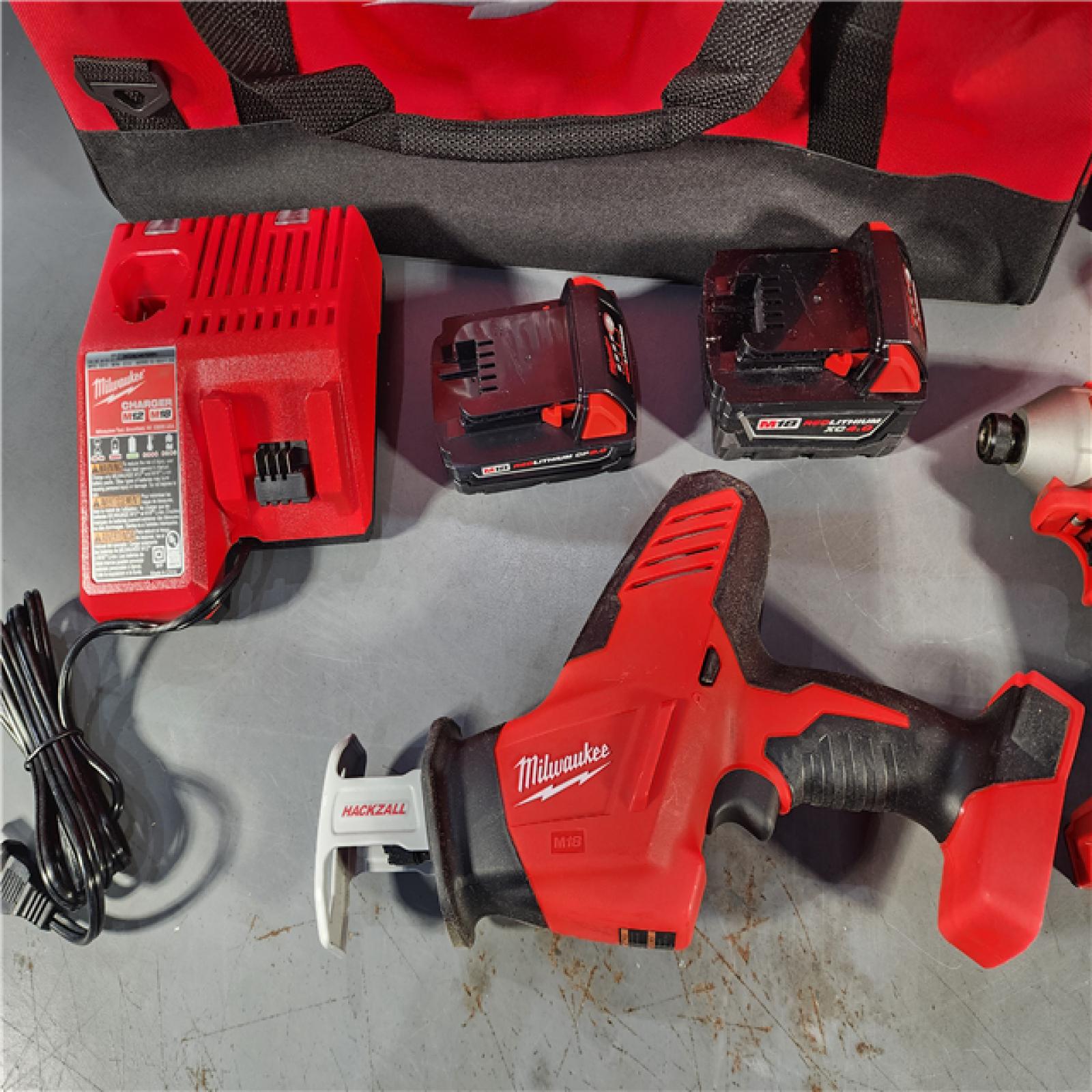 HOUSTON LOCATION - AS-IS Milwaukee M18 18-Volt Lithium-Ion Brushless Cordless Combo Kit (4-Tool) with 2-Batteries, 1-Charger and Tool Bag