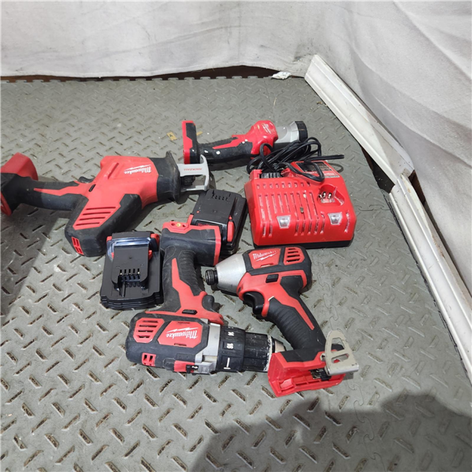 Houston location AS-IS MILWAUKEE M18 18-Volt Lithium-Ion Cordless Combo Kit 4-Tool with Two 2.0 Ah Batteries, Charger and Tool Bag