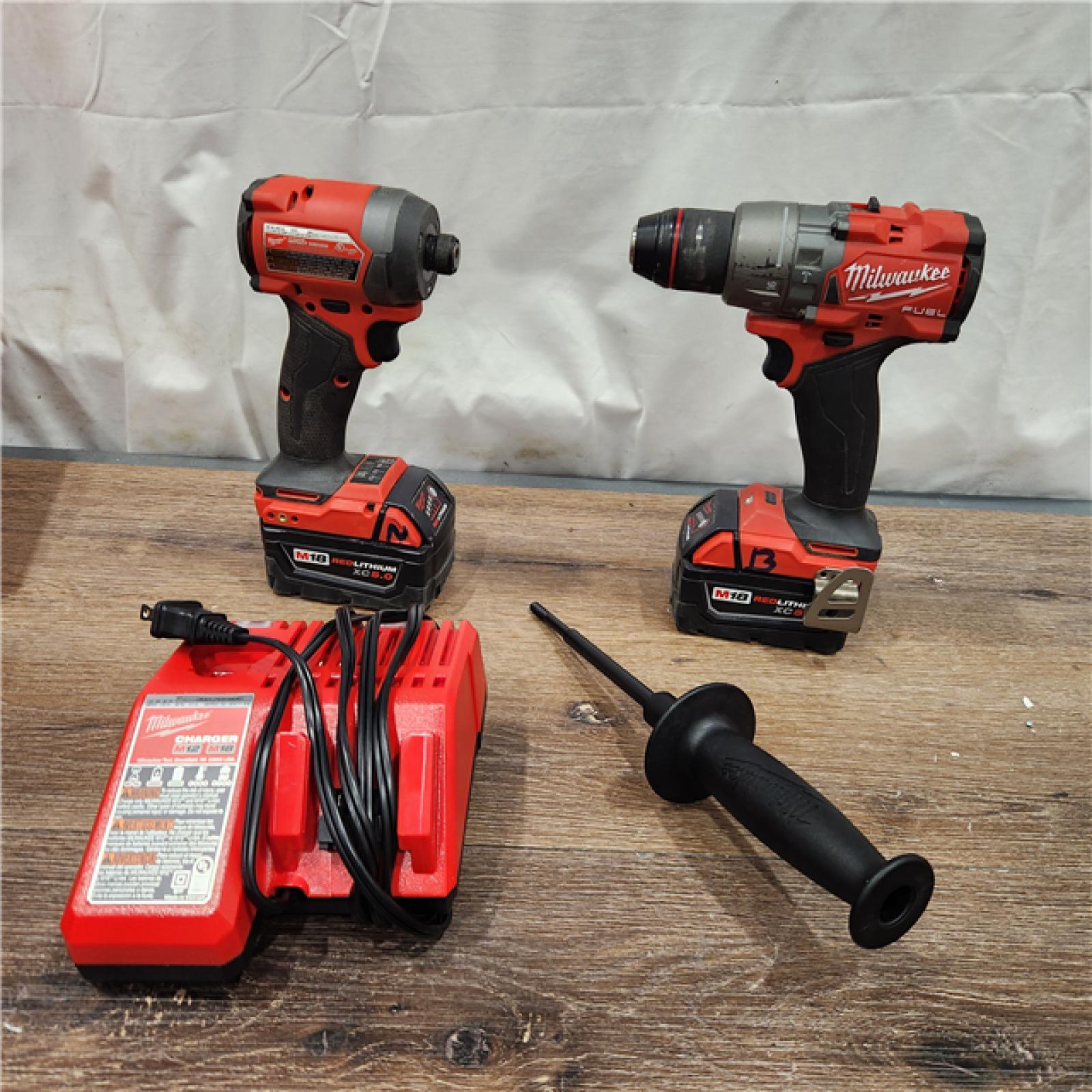 AS-IS Milwaukee M18 FUEL 18V Lithium-Ion Brushless Cordless Hammer Drill and Impact Driver Combo Kit (2-Tool) with 2 Batteries