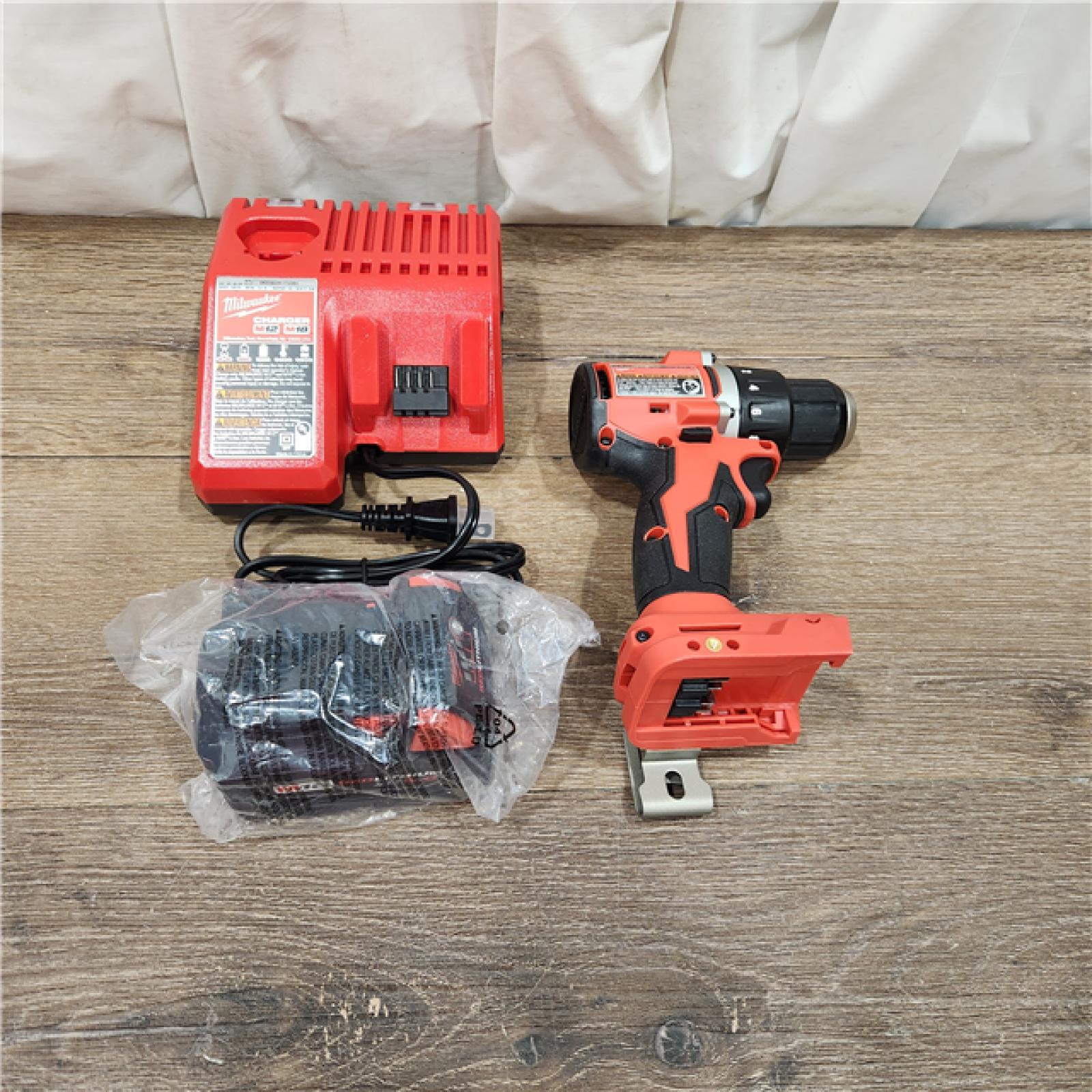 AS-IS Milwaukee  M18 18-Volt Lithium-Ion Brushless Cordless 1/2 in. Compact Drill/Driver with M18 5.0Ah Battery and Charger