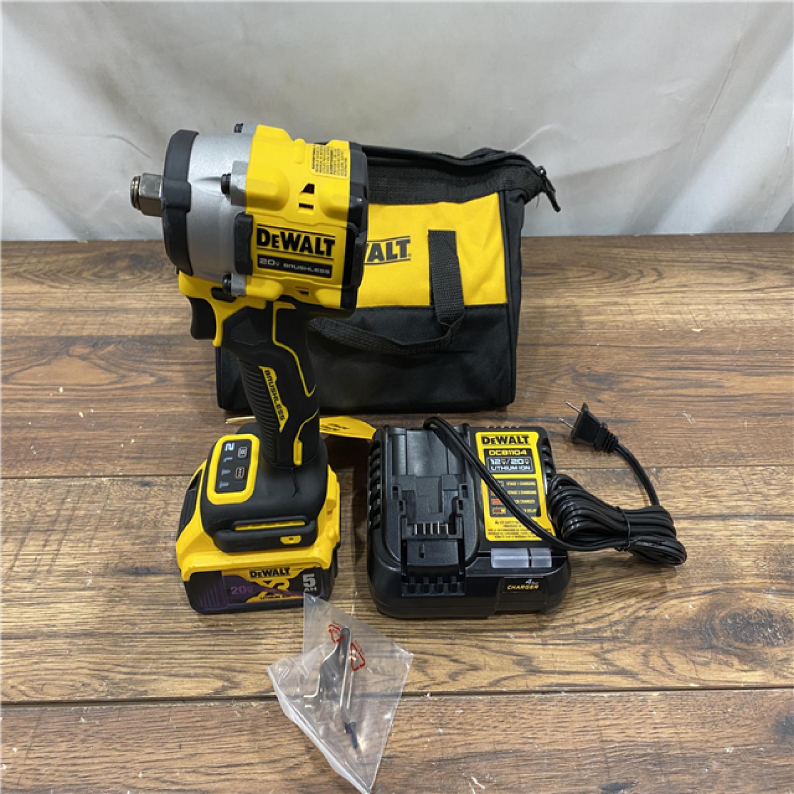 AS IS DEWALT ATOMIC 20V MAX Lithium-Ion Brushless Cordless 1/2 in. Variable Speed Impact Wrench Kit with 5 Ah Battery and Charger