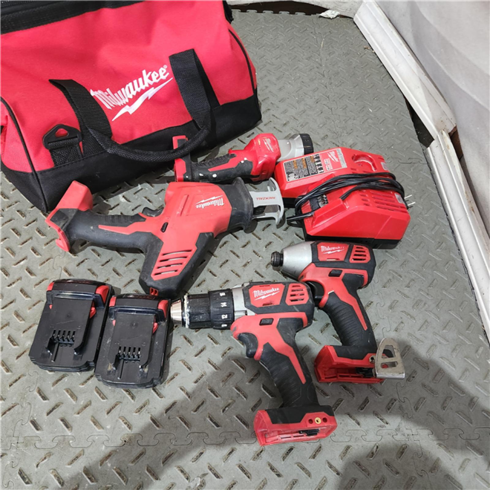 Houston location AS-IS MILWAUKEE M18 18-Volt Lithium-Ion Cordless Combo Kit 4-Tool with Two 2.0 Ah Batteries, Charger and Tool Bag