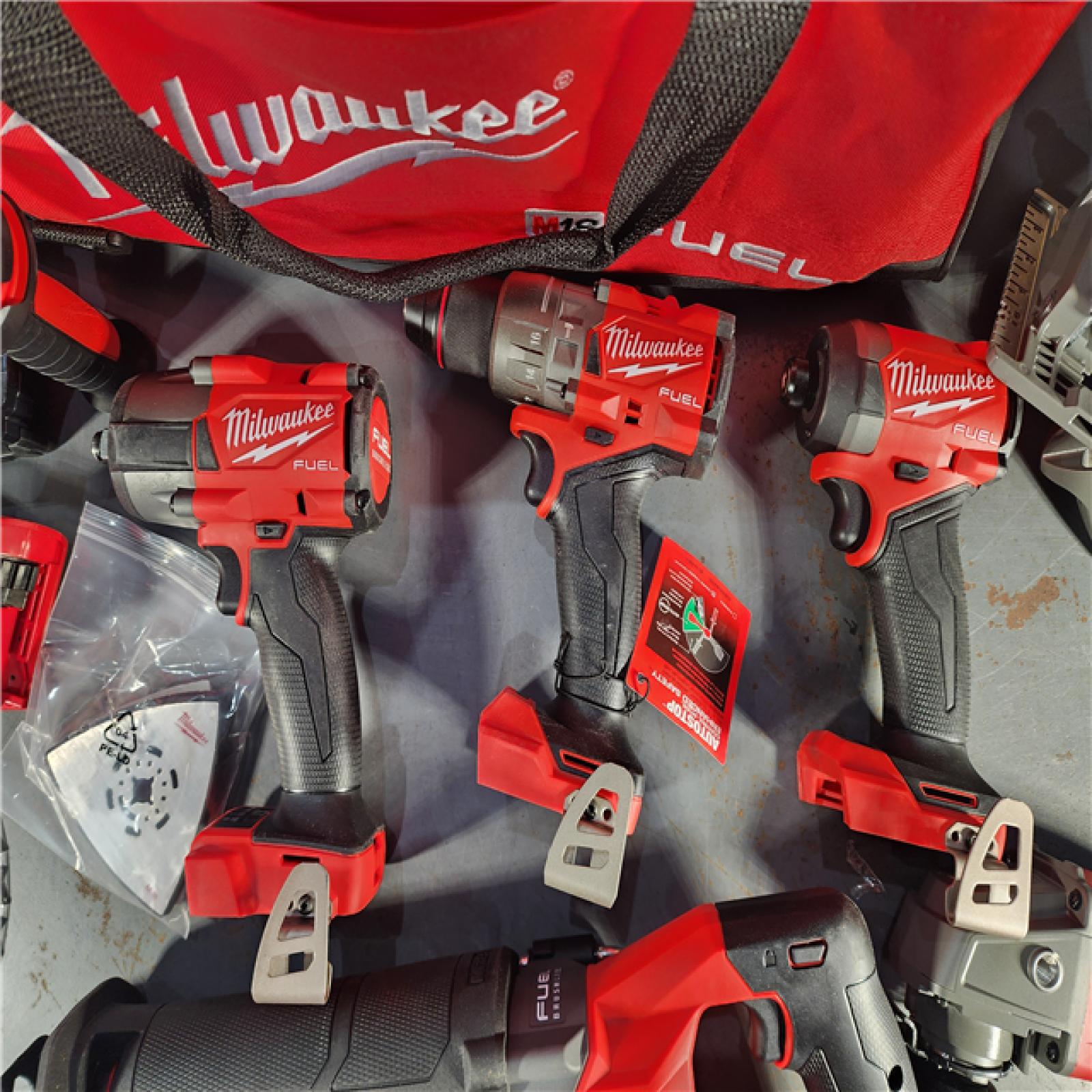 HOUSTON LOCATION - AS-IS Milwaukee M18 FUEL 18V Lithium-Ion Brushless Cordless Combo Kit with Two 5.0 Ah Batteries  1 Charger  2 Tool Bags (7-Tool)