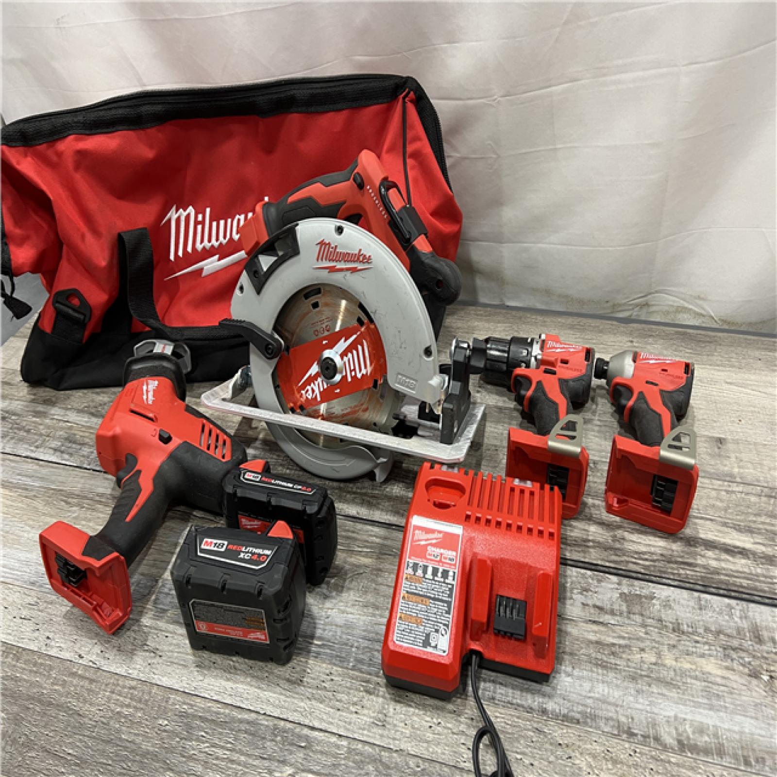 AS-IS Milwaukee M18 18-Volt Lithium-Ion Brushless Cordless Combo Kit (4-Tool) with 2-Batteries, 1-Charger and Tool Bag