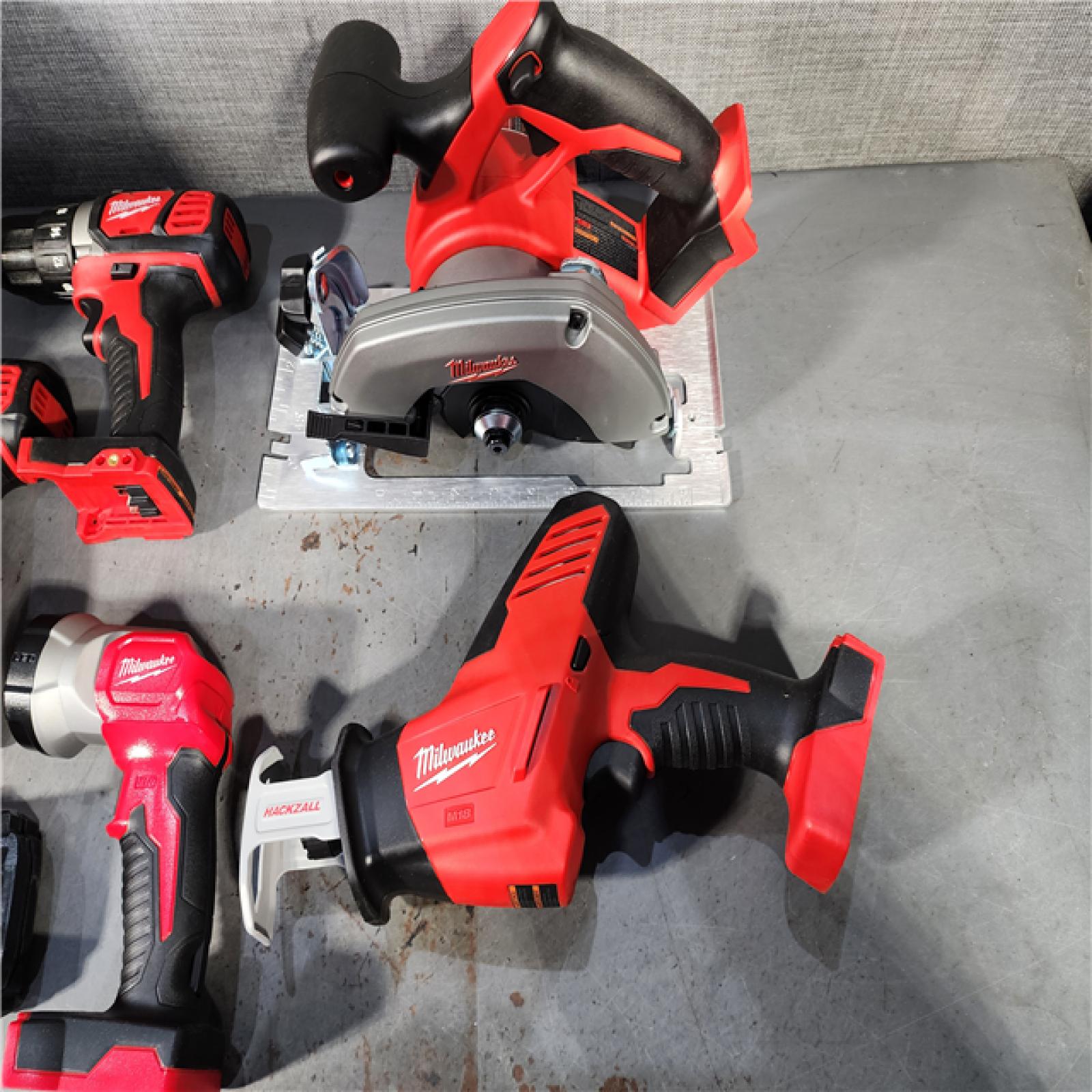 HOUSTON LOCATION - AS-IS (APPEARS LIKE NEW) Milwaukee M18 18-Volt Lithium-Ion Cordless Combo Tool Kit (5-Tool) with (1) 3.0Ah and (1) 1.5Ah Battery, (1) Charger, (1) Tool Bag