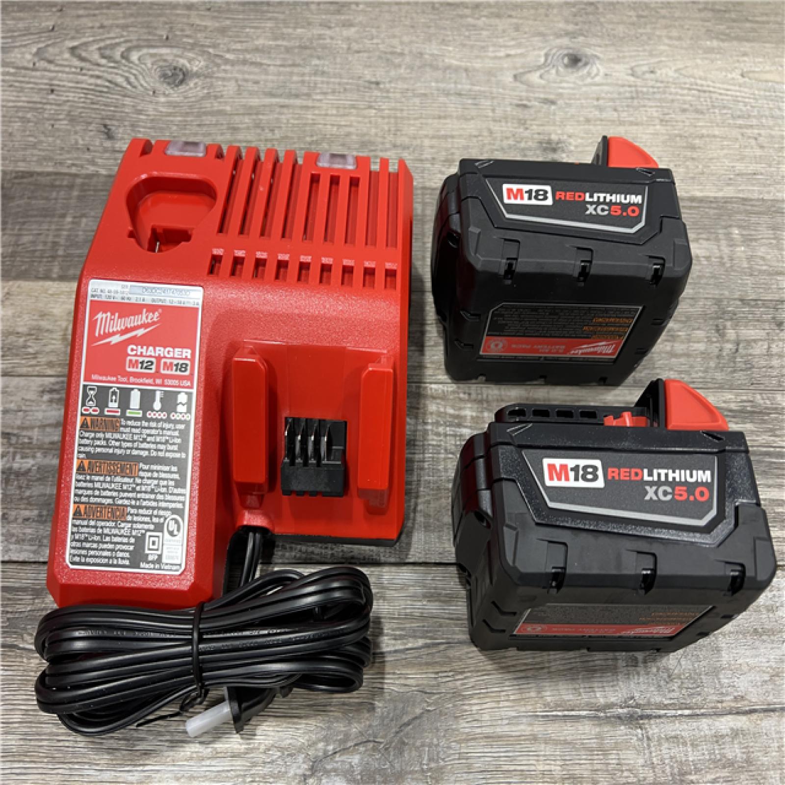 AS-IS Milwaukee M18 18-Volt Lithium-Ion XC Starter Kit with Two 5.0Ah Batteries / Charger (48-59-1852B)