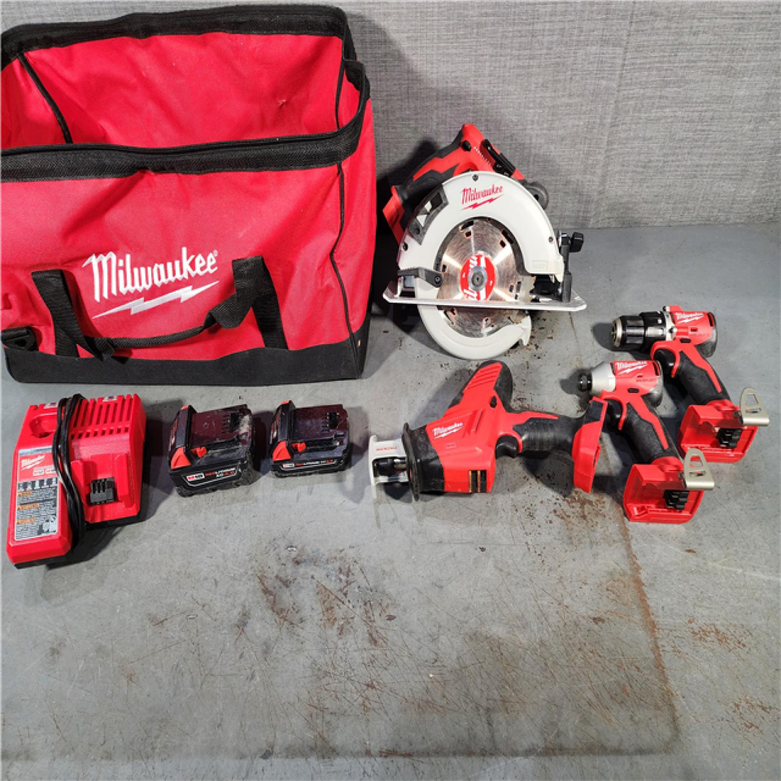 HOUSTON LOCATION - AS-IS Milwaukee M18 18-Volt Lithium-Ion Brushless Cordless Combo Kit (4-Tool) with 2-Batteries, 1-Charger and Tool Bag