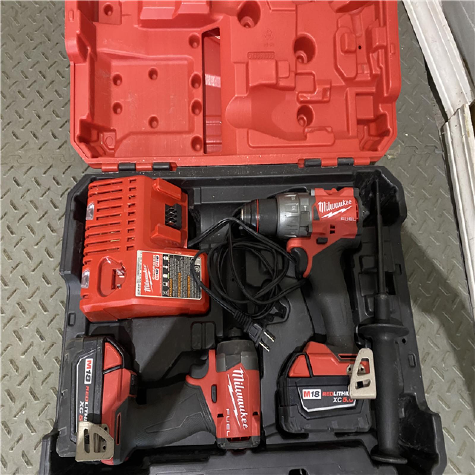 Houston location AS-IS Milwaukee 3697-22 M18 FUEL 1/2 Hammer Driller/Driver &1/4 Hex Impact Driver 2 Tool Combo Kit