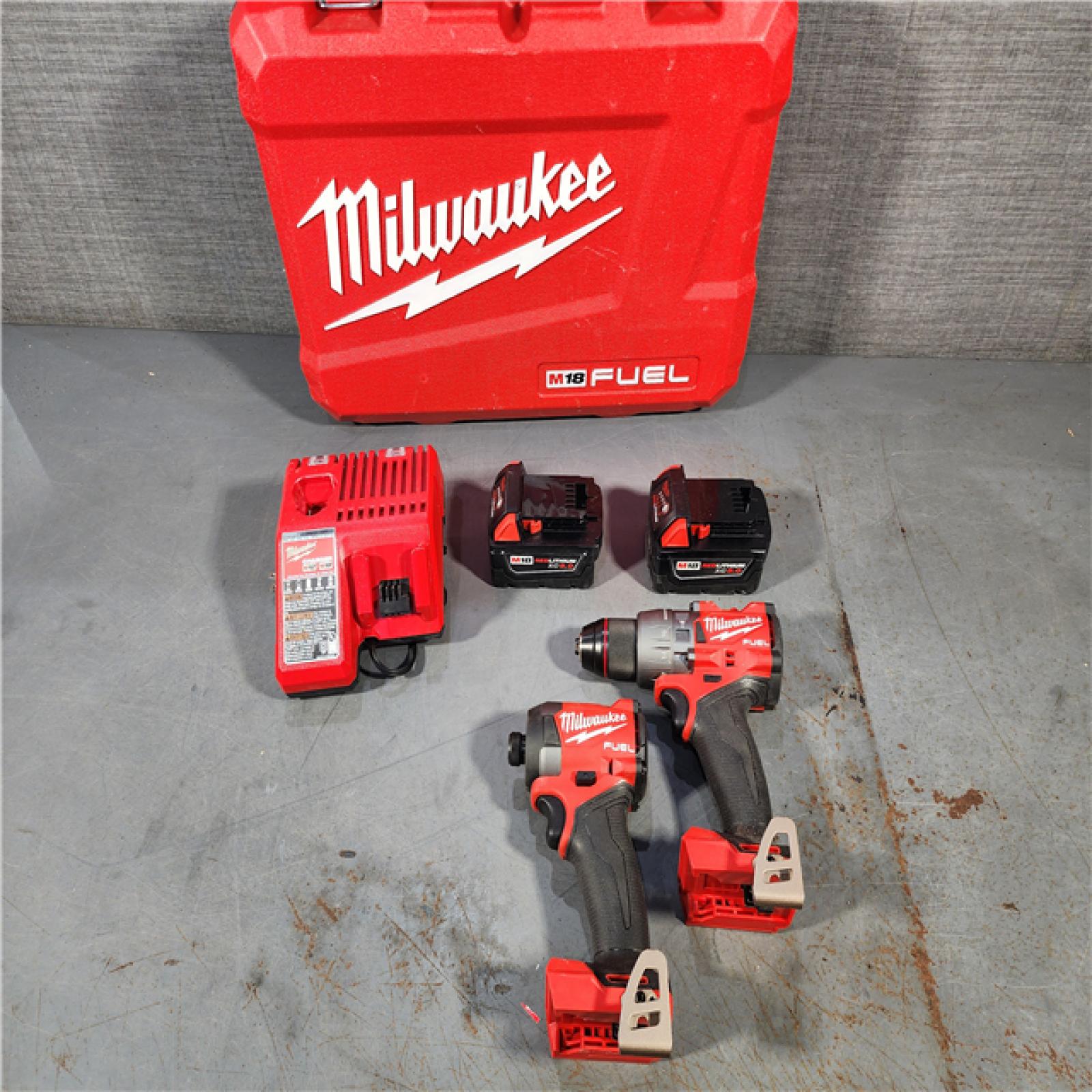 HOUSTON LOCATION - AS-IS Milwaukee M18 FUEL 18V Lithium-Ion Brushless Cordless Hammer Drill and Impact Driver Combo Kit (2-Tool) with 2 Batteries