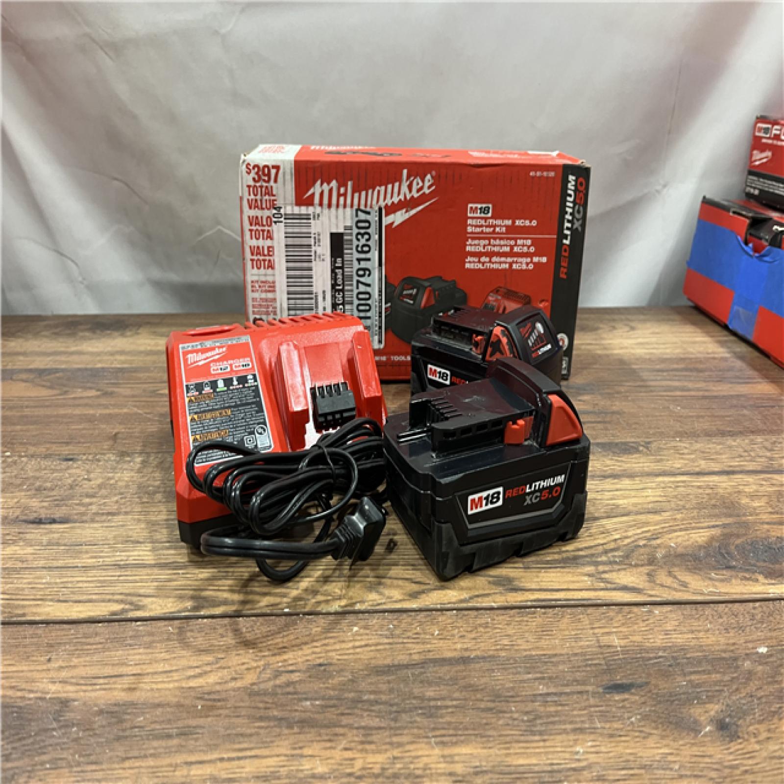 AS-IS Milwaukee M18 18-Volt Lithium-Ion XC Starter Kit with Two 5.0Ah Batteries / Charger (48-59-1852B)