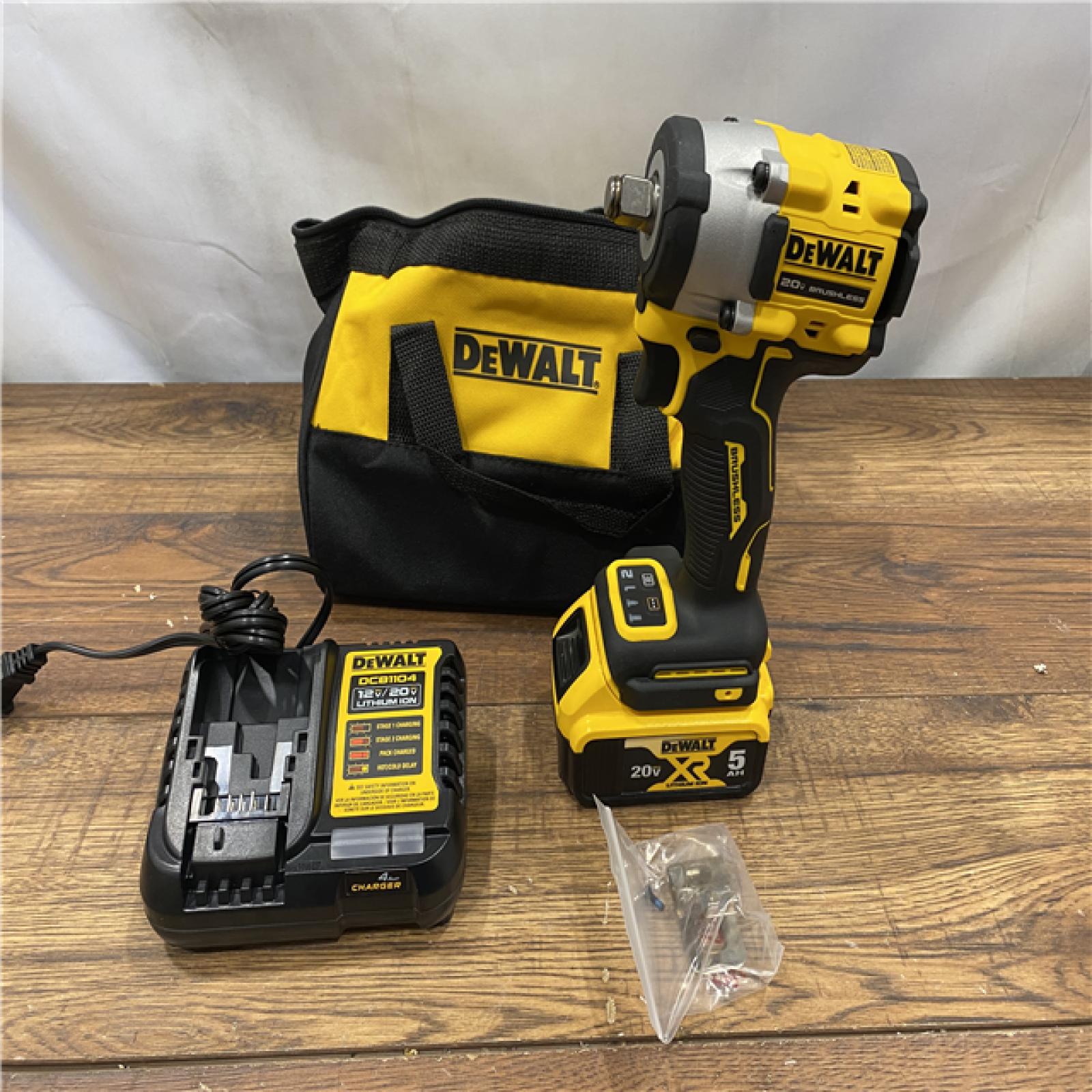 AS IS DEWALT ATOMIC 20V MAX Lithium-Ion Brushless Cordless 1/2 in. Variable Speed Impact Wrench Kit with 5 Ah Battery and Charger