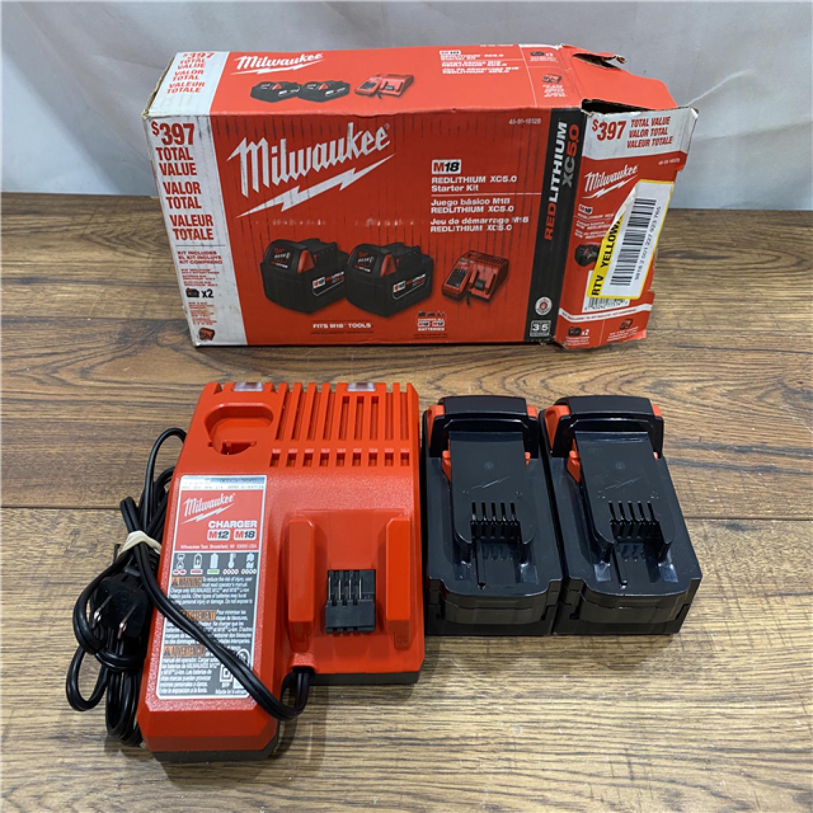 AS IS Milwaukee M18 18-Volt Lithium-Ion XC Starter Kit with Two 5.0Ah Batteries / Charger (48-59-1852B)