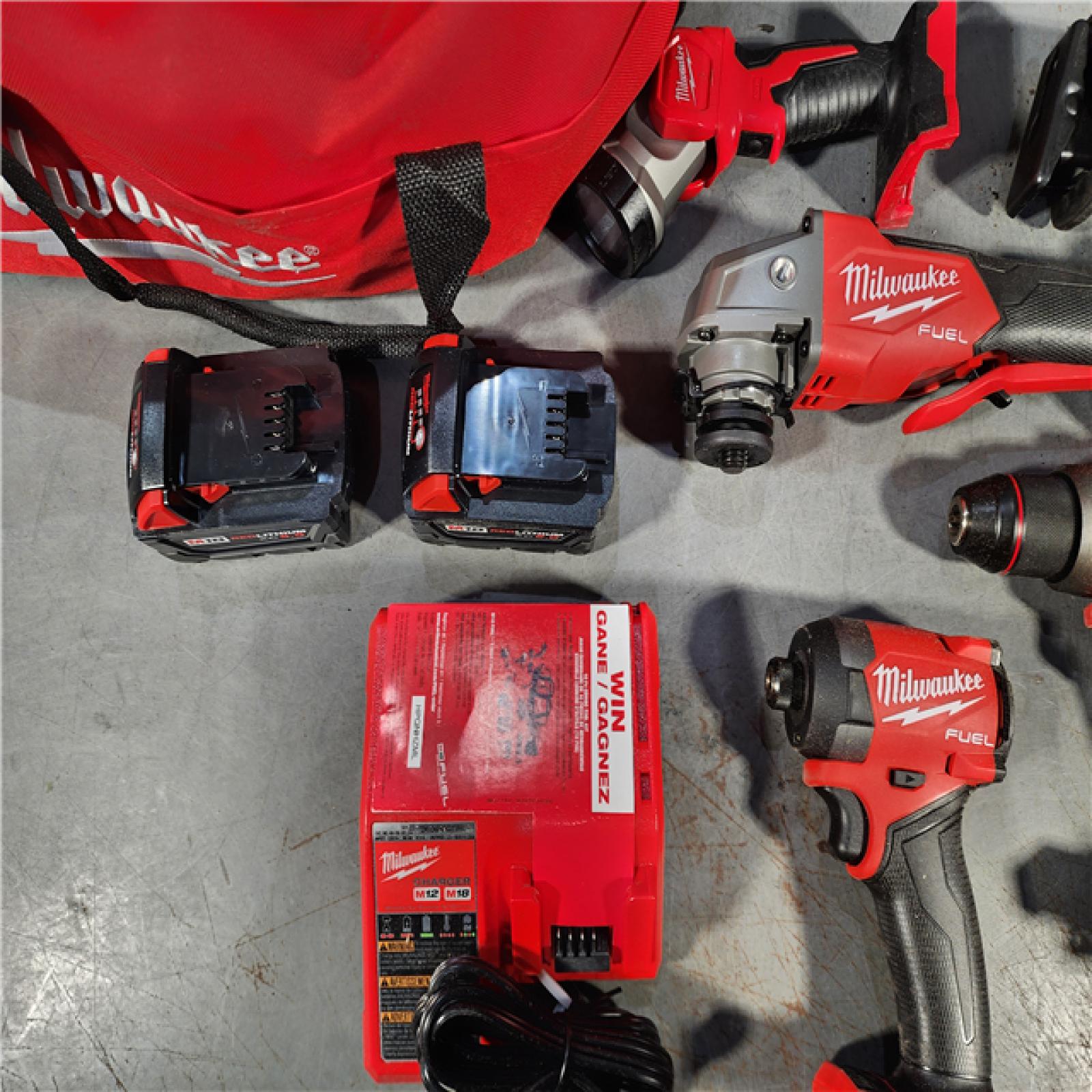 HOUSTON LOCATION - AS-IS MILWAUKEE 7 - TOOL COMBO KIT W/ (2) BATTERY & CHARGER